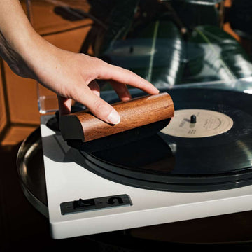 Person placing a record on a turntable