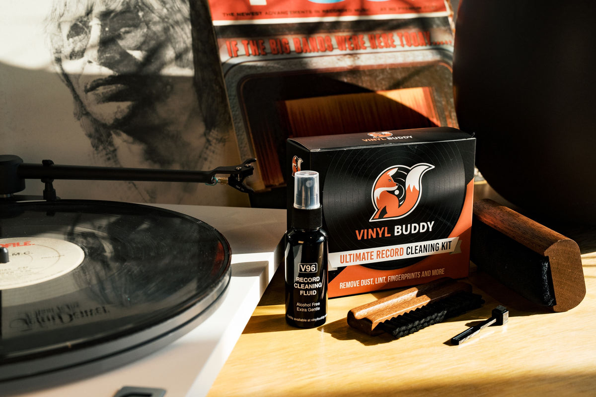 Vinyl Buddy Ultimate Record Cleaning Kit with brushes and cleaning fluid next to a turntable